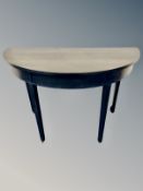 A contemporary demi lune table,