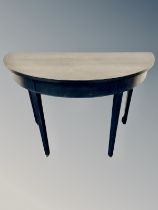 A contemporary demi lune table,