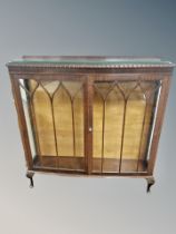 An Edwardian bow fronted oak display cabinet,