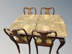 A figured walnut seven piece dining room suite comprising of extending dining table,