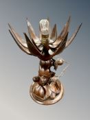 A South East Asian heavily carved hardwood lotus table lamp,