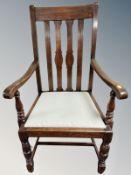 An Edwardian oak framed armchair