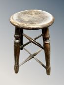 A 19th century oak stool with double-X under stretcher,