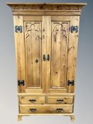 A contemporary pine gothic style double door wardrobe,