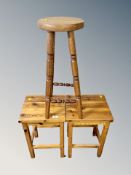 A pair of stained pine stools and one other