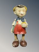 A vintage plaster wind-up Pinnochio toy,