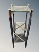 A contemporary glass and chrome three tier stand,