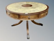 A Regency style mahogany drum coffee table with leather inset panel,