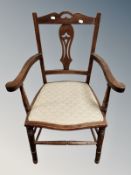 An Edwardian oak armchair