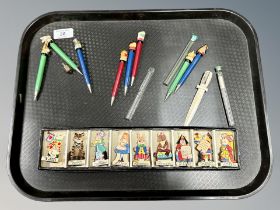 An interesting collection of Alice in Wonderland pencil sharpeners with eight lead pencils matching