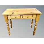 A contemporary pine two drawer side table,