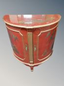 A Japanese red lacquered bow fronted side cabinet,
