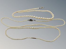A graduated pearl necklace on yellow gold clasp, together with two further cultured pearl necklaces.