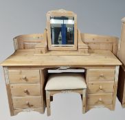 A washed pine dressing table with mirror back and matching foostool, width 143 cm,