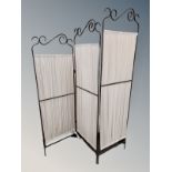 A wrought metal fabric room divider