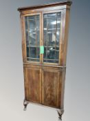 An Edwardian mahogany glazed double door corner cabinet