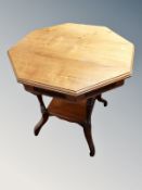 An Edwardian walnut octagonal two tier occasional table,