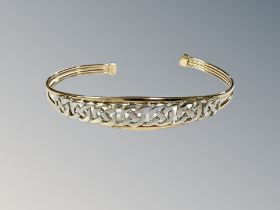 A 9ct two-tone gold bangle, 6.3g.