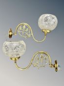 A pair of Edwardian Art Nouveau brass wall lights with frosted and etched globular shades,