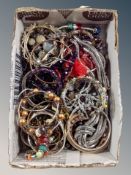 A small box of mixed costume jewellery, bangles,