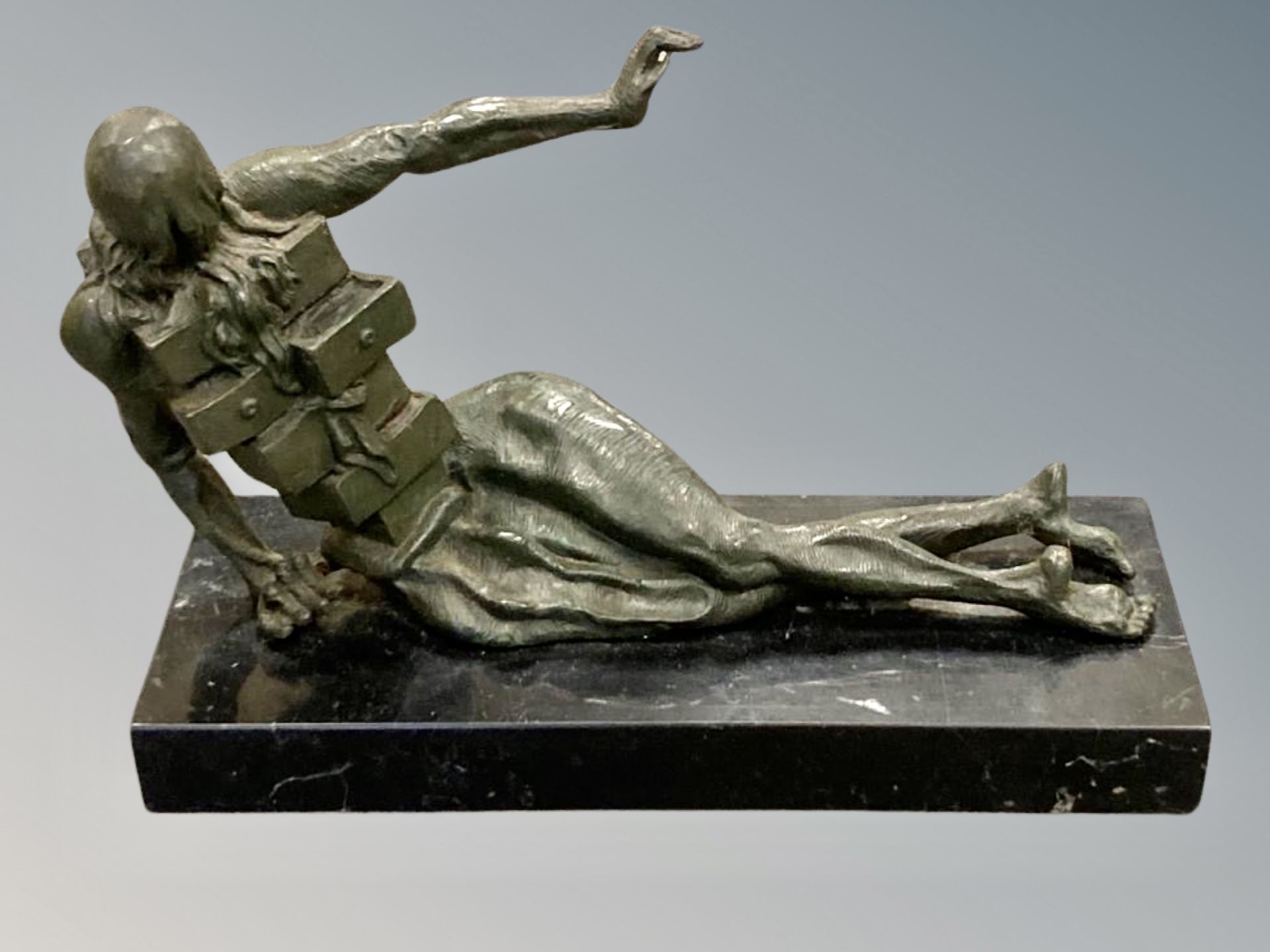 A contemporary patinated bronze sculpture on black marble plinth,