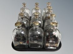 Twelve Holme Gaard bottles all with metal stoppers