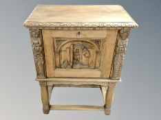 A Danish heavily carved oak single cabinet on stand,