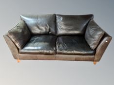 A contemporary brown stitched leather two seater settee,