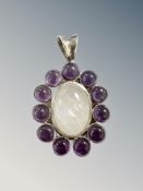 A silver pendant set with cabochon stones