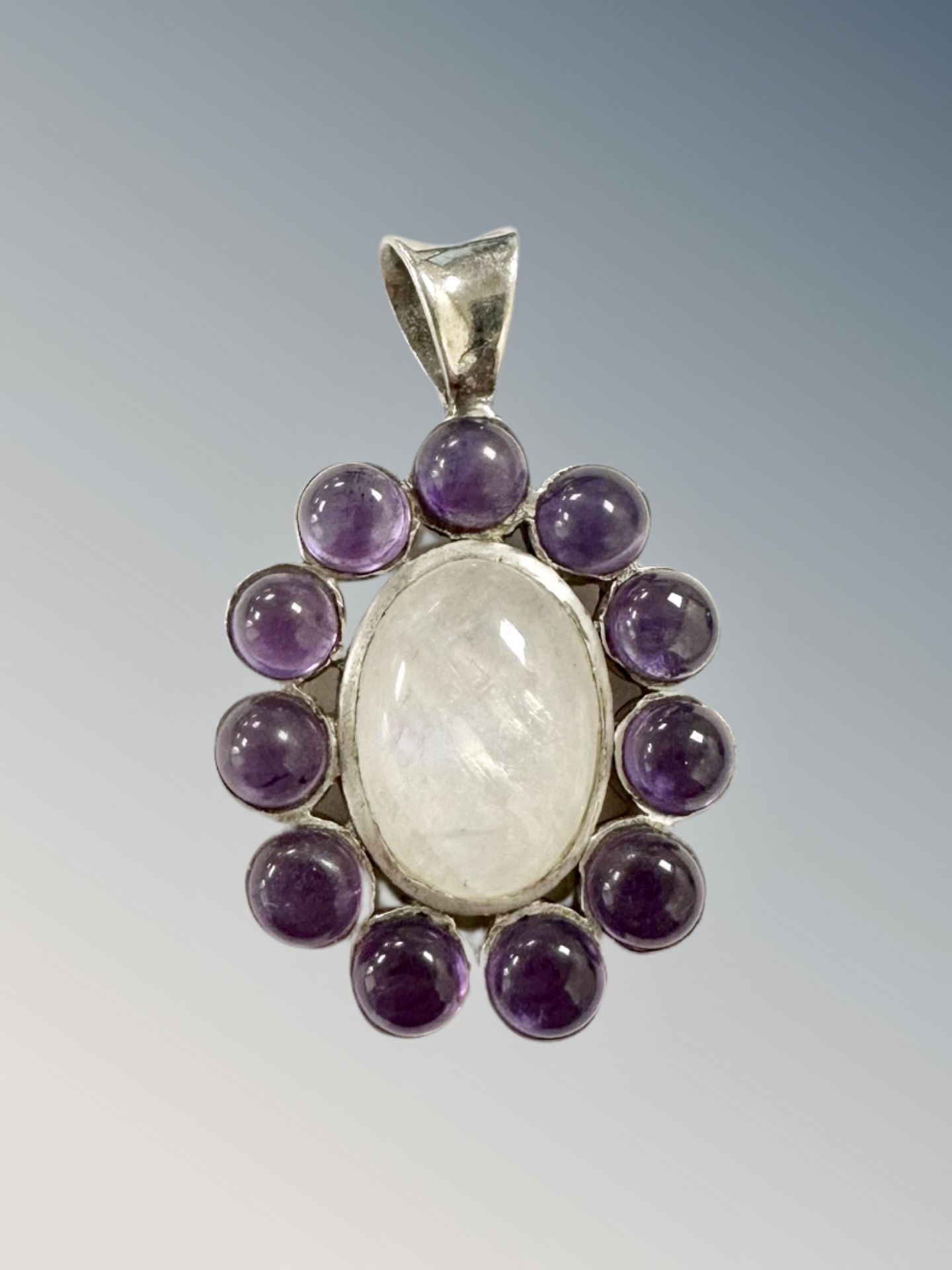 A silver pendant set with cabochon stones