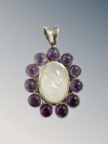 A silver pendant set with cabochon stones