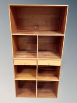 A Danish teak two-section open bookcase,
