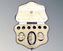 A fine quality cased silver gilt and purple enamel buckle, pair of shoe buckles, and six buttons,