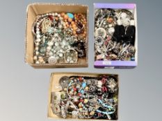 A collection of costume jewellery in three small boxes, beaded necklaces,