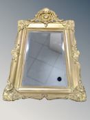 An early 20th century gilt gesso bevelled mirror,