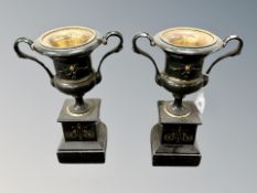 A pair of Victorian gilded spelter urns on black slate stepped bases, height 26 cm.