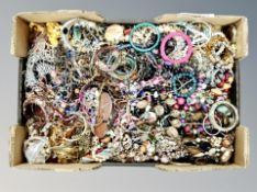 A large box of costume jewellery, bangles,