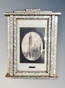A monochrome picture in ornate mother of pearl effect frame 36 cm x 47 cm