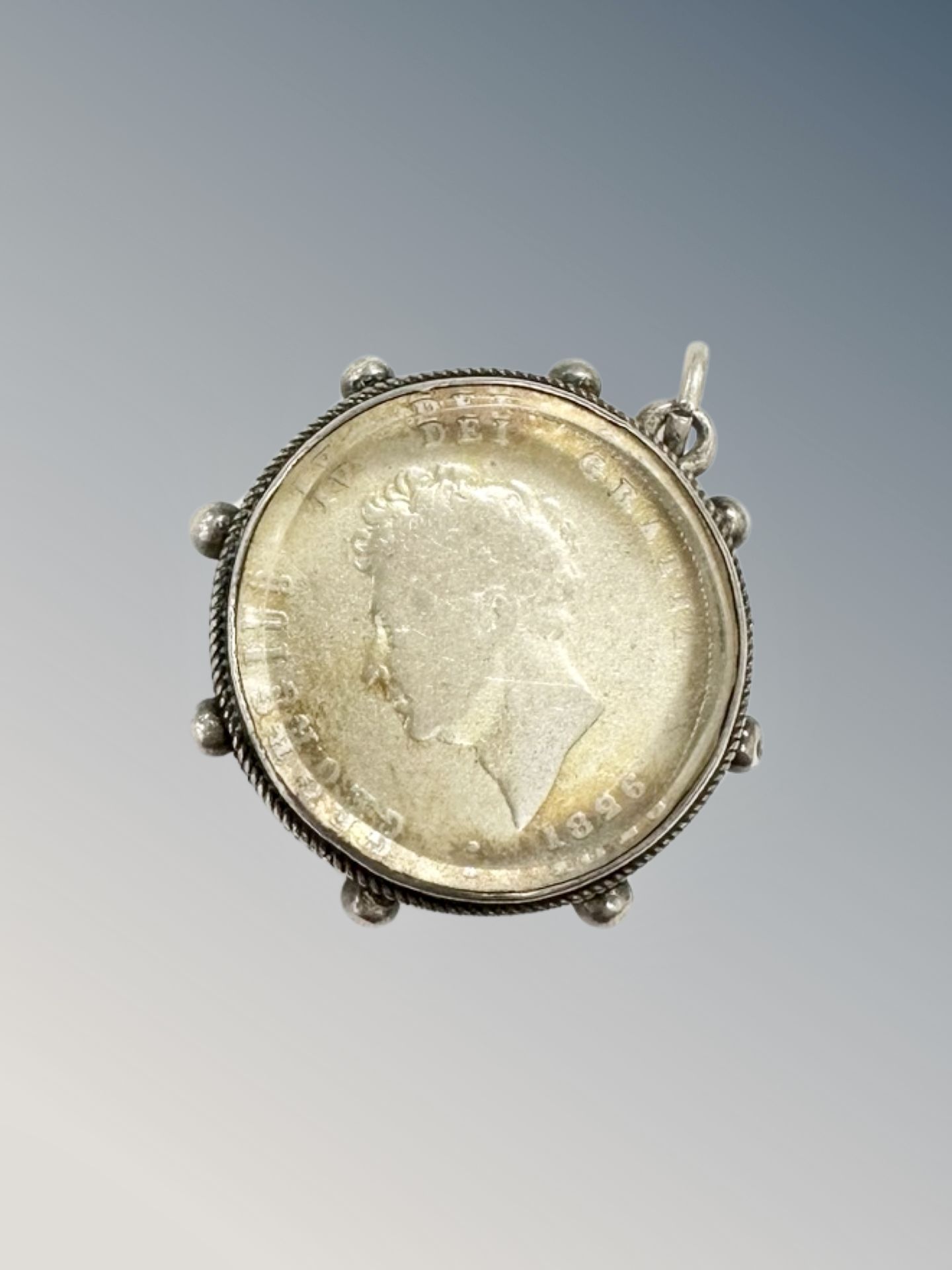 An 1826 silver shilling in mount