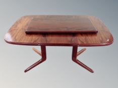 A Danish rosewood extending dining table with two leaves,