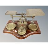 A large set of 19th century brass and oak postal scales with weights,