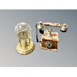 An onyx vintage style telephone and a Hermle clock under dome