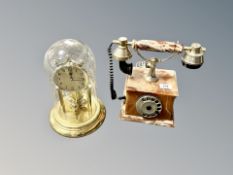 An onyx vintage style telephone and a Hermle clock under dome
