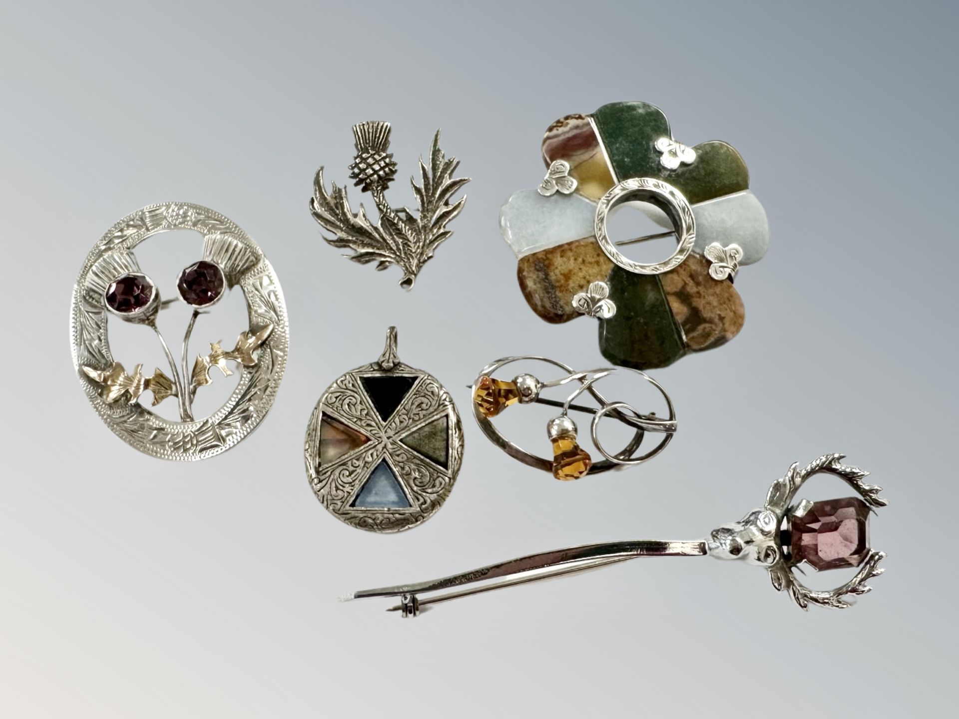 A collection of Scottish brooches, some examples in silver, agate etc.