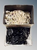 Two boxes of faux pearls and mourning jewellery,