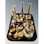 A group of brass ware, two pairs of candlesticks, chamber stick, shallow dish,