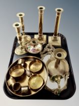 A group of brass ware, two pairs of candlesticks, chamber stick, shallow dish,