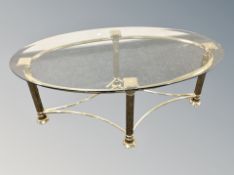 A brass glass topped oval coffee table,