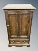 An Ercol stained elm single door cabinet,