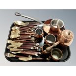 A group of copper kitchenalia, measures, chocolate pot, cast iron pan,